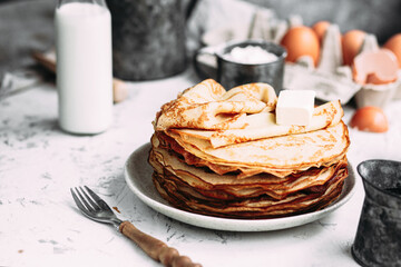 Thin pancakes with butter in a plate
