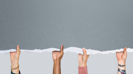 Multicultural hands holding a gray mockup paper wallpaper