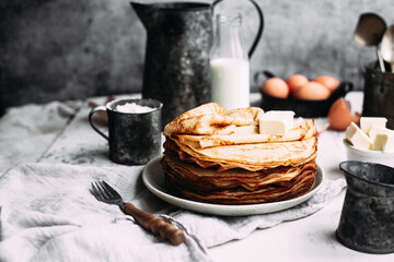 Thin pancakes with butter in a plate
