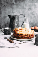 Thin pancakes with butter in a plate