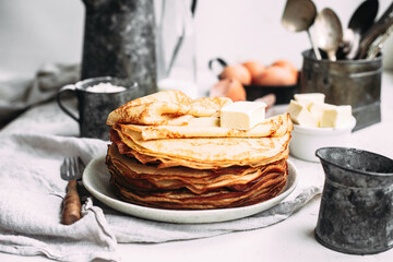 Thin pancakes with butter in a plate