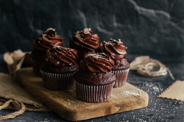 Delicious chocolate cupcakes. Cupcakes on a concrete table. Chocolate biscuit and chocolate ganache