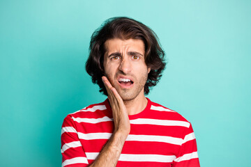 Portrait of handsome confused terrified brown-haired guy bad news reaction isolated over bright green turquoise color background