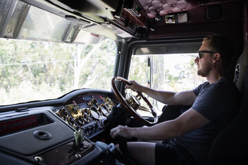 caucasian man driving large truck cabin steer transport lorry strong sunglasses work travel...