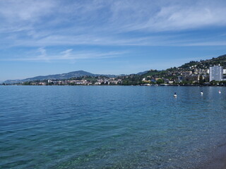 Fototapeta premium Famous view of Lake Geneva and european Montreux city in canton Vaud in Switzerland, clear blue sky in 2017 warm sunny summer day on July.