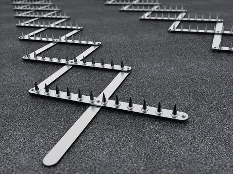 Road spike or tire trap on asphalt background. 3D illustration