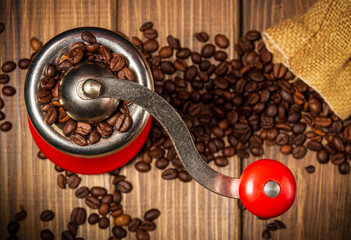 Coffee grinder and coffee beans on vintage boards. Idea for making a coffee drink top view