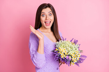 Profile photo of impressed girl hold flowers wear lilac sweater isolated on pink color background