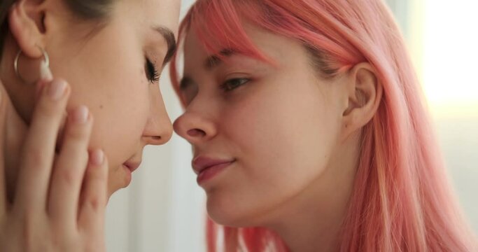 Loving female gay couple touching forehead with tenderness