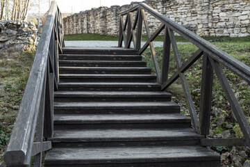 Fototapeta premium Old wooden staircase leading up, rustic staircase with steps and wooden railings