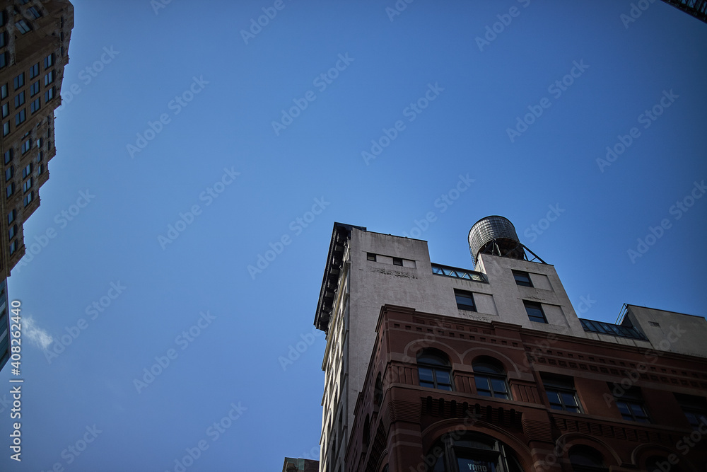 Wall mural building in new york with blue sky