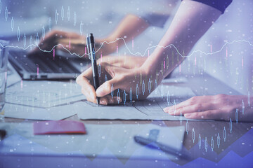 Multi exposure of woman hands typing on computer and financial chart hologram drawing. Stock market analysis concept.