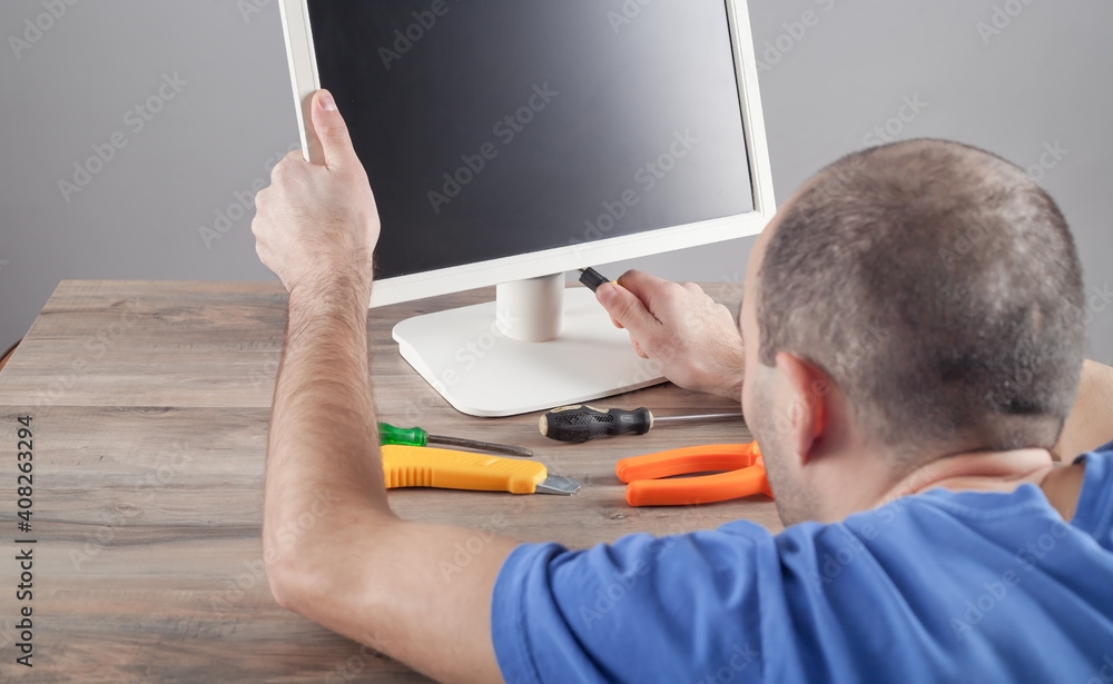 Wall mural electrician engineer repairing computer monitor.