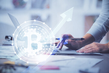 Double exposure of woman hands typing on computer and crypto market theme hologram drawing....