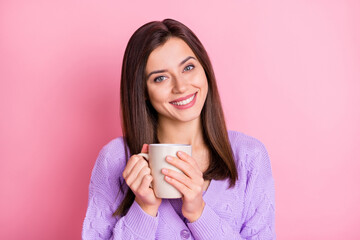 Portrait of optimistic girl hold cup wear lilac sweater isolated on pink color background