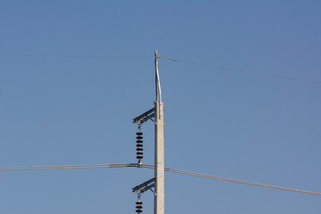 Power lines equipment with electric pole on blue sky background.