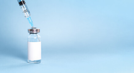 A bottle with a vaccine and a syringe in close-up. Concept of a vaccine against coronavirus, covid-19, flu, measles