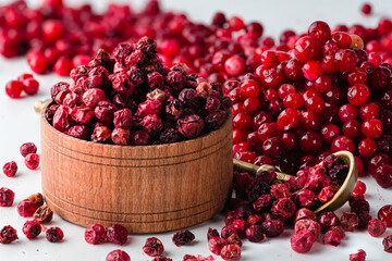 Fresh organic cranberries and a bowl with dried cranberries