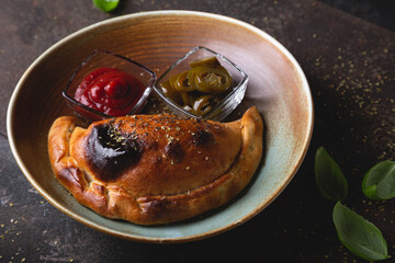 Calzone pizza with sauce and hot pepper