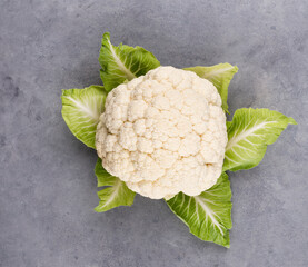 A head of fresh cauliflower. Healthy eating and vegetarianism. Color background.