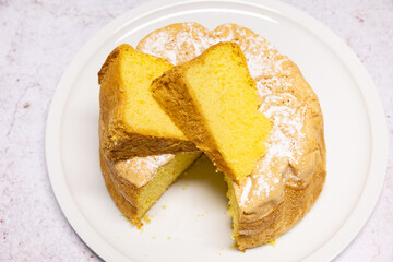 Homemade Savoie cake on a pretty white porcelain dish