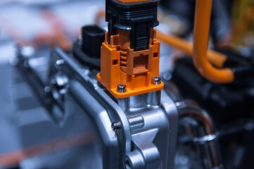 Chassis of the electric car with powertrain and power connections closeup. Blue toned. EV car drivetrain at maintenance.