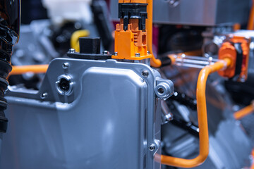 Chassis of the electric car with powertrain and power connections closeup. Blue toned. EV car...