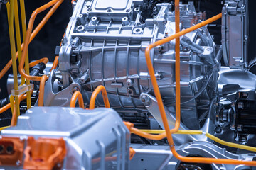 Chassis of the electric car with powertrain and power connections closeup. Blue toned. EV car...