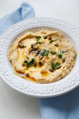 homemade hummus, white plate and blue napkin, handmade, homemade food, restaurant, healthy food, chickpeas, organic food, Israeli food, vegetarian, healthy breakfast, home cooking, family cooking