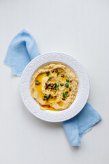 homemade hummus, white plate and blue napkin, handmade, homemade food, restaurant, healthy food, chickpeas, organic, Israeli food, vegetarian food, healthy breakfast, home cooking,family cookin