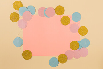 Minimal concept of ballon shape circles surrounding paper card in the middle. Pink copy space with pastel beige background.