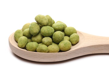 Wasabi coated peanuts in wooden spoon isolated on white background