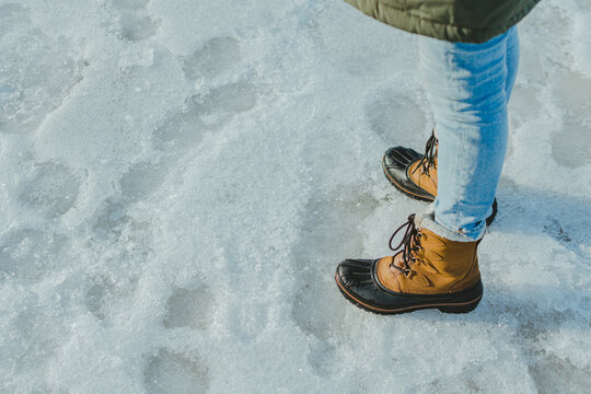 High Angle Shot Of Woman Wearing Boots On The Snow In Latvia, Jurmala