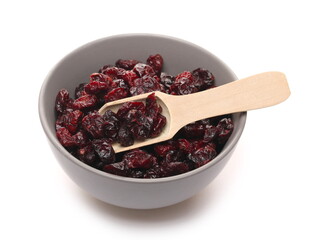 Dried cranberries in bowl with wooden spoon isolated on white background