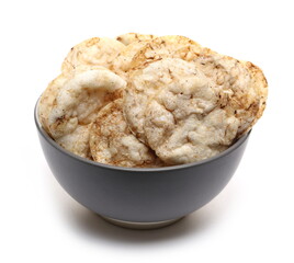 Rice chips, crisps with sea salt and black pepper in bowl isolated on white background