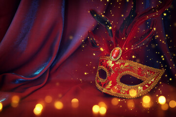 Photo of elegant and delicate Venetian mask over red silk background