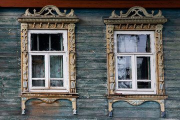 Russia, Tver region. 07.18.2020: Old wooden house with windows in beautiful carved platbands