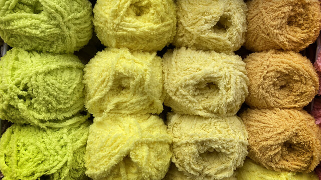 Blossoming Balls Of Thread For Needlework. Bright Colors In Everyday Hobby. The Texture Of Fine Threads Woven Together. Yellow Fluffy Threads.