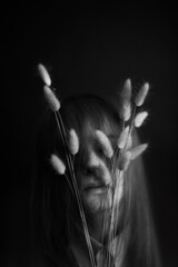 People and dry plants. Minimalistic black and white portrait of a girl and a herbarium. Space for...