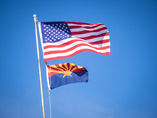 US flag and Arizona state flag with blue skies