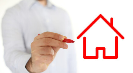 Fototapeta na wymiar Hand of man drawing a red house on a glass. Investment Concept of buy or sell house.