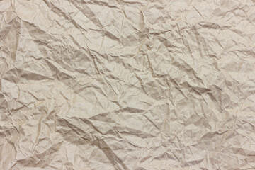 The texture of crumpled brown craft paper.