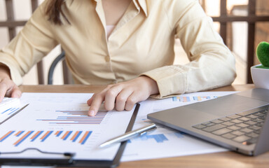 Fototapeta premium Financial businesswomen analyze the graph of the company's performance to create profits and growth, Market research reports and income statistics, Financial and Accounting concept.