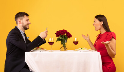 Angry Girlfriend Shouting At Indifferent Boyfriend During Date, Yellow Background