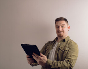 Young man with a tablet computer against white background