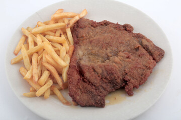 veal breaded meat with fried potatoes