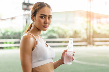 woman drink water after hard workout prevent dehydration heat stroke. - obrazy, fototapety, plakaty