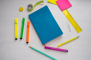 Turquoise cover planner with a pen, markers, ruler, stickers.. Planning and smart time management concept