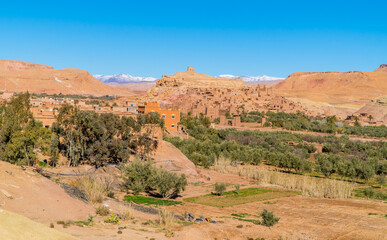 Panorama view of the stunning town of Aid Ben Haddou in the Moroccan desert with the Atlas Mountain Range in the background