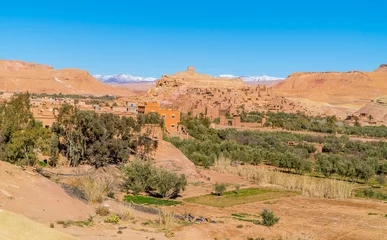 Foto op Plexiglas Panorama view of the stunning town of Aid Ben Haddou in the Moroccan desert with the Atlas Mountain Range in the background © Jack Krier